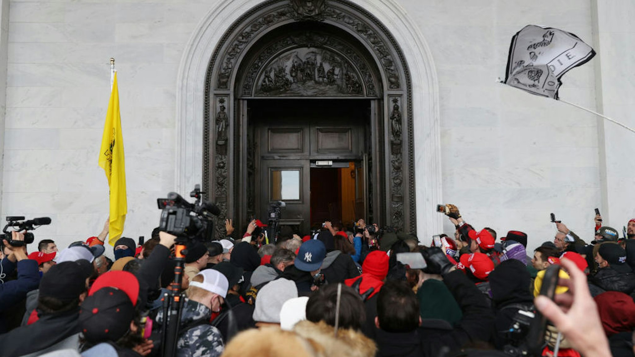 WASHINGTON, DC - JANUARY 06: Protesters gather at the door of the U.S. Capitol Building on January 06, 2021 in Washington, DC. Pro-Trump protesters entered the U.S. Capitol building after mass demonstrations in the nation's capital during a joint session Congress to ratify President-elect Joe Biden's 306-232 Electoral College win over President Donald Trump.