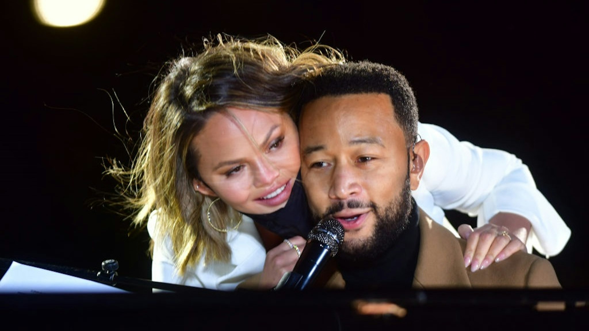 PHILADELPHIA, PA - NOVEMBER 02: Singer John Legend is joined onstage by his wife, Chrissy Teigen, while performing before Democratic vice presidential nominee Sen. Kamala Harris (D-CA) speaks at a drive-in election eve rally on November 2, 2020 in Philadelphia, Pennsylvania.