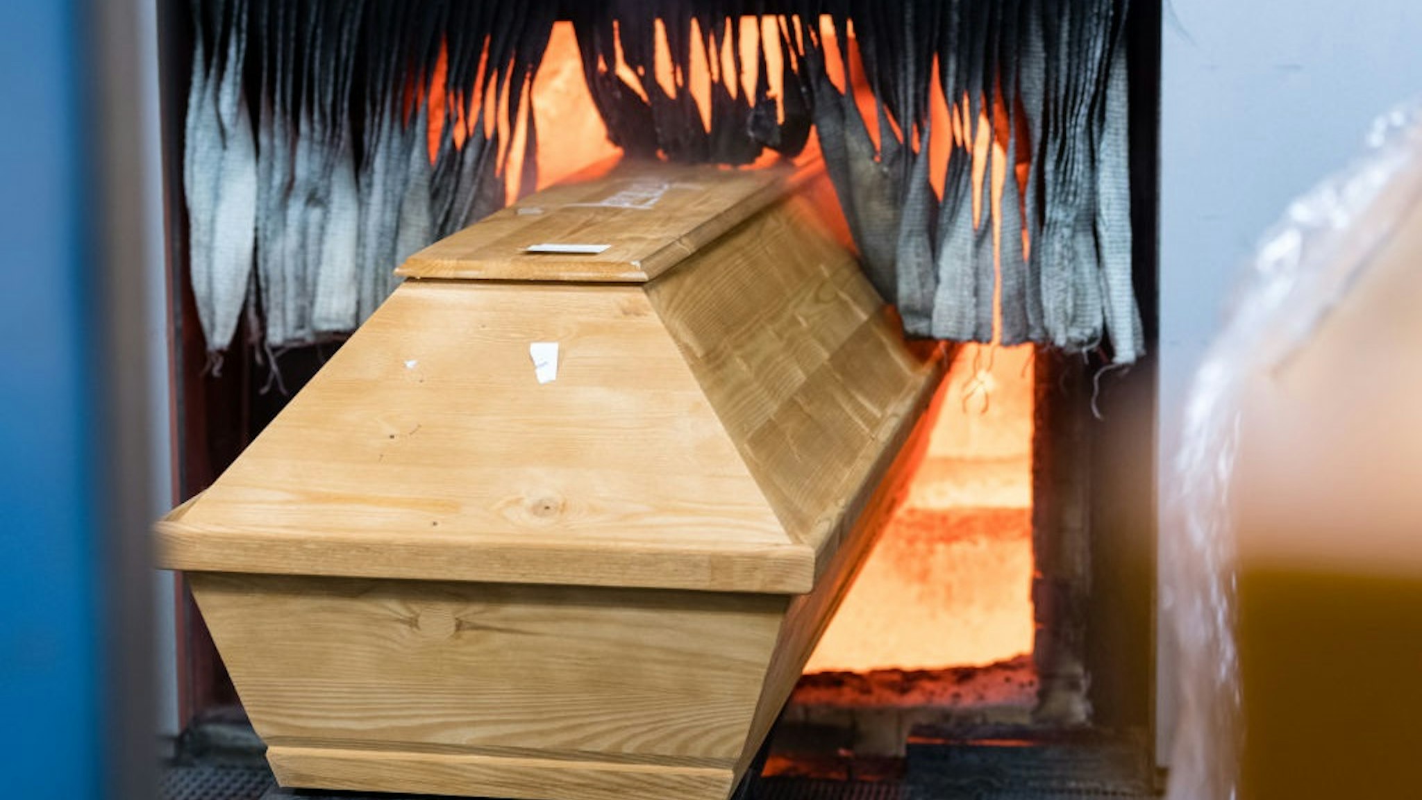 A coffin is moved for cremation into the furnace at the crematorium in Meissen, eastern Germany on January 13, 2021, during the ongoing novel coronavirus (Covid-19) pandemic.