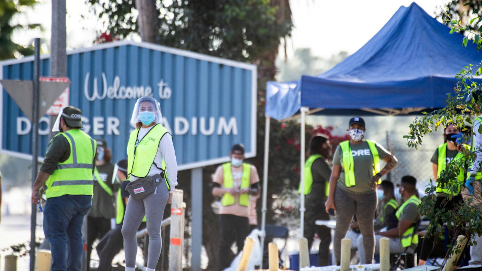 LOS ANGELES, CA - JANUARY 15: CORE employees are on hand to direct traffic at Dodger Stadium in Los Angeles after it was turned into a COVID-19 drive-thru vaccination site on Friday, January 15, 2021.