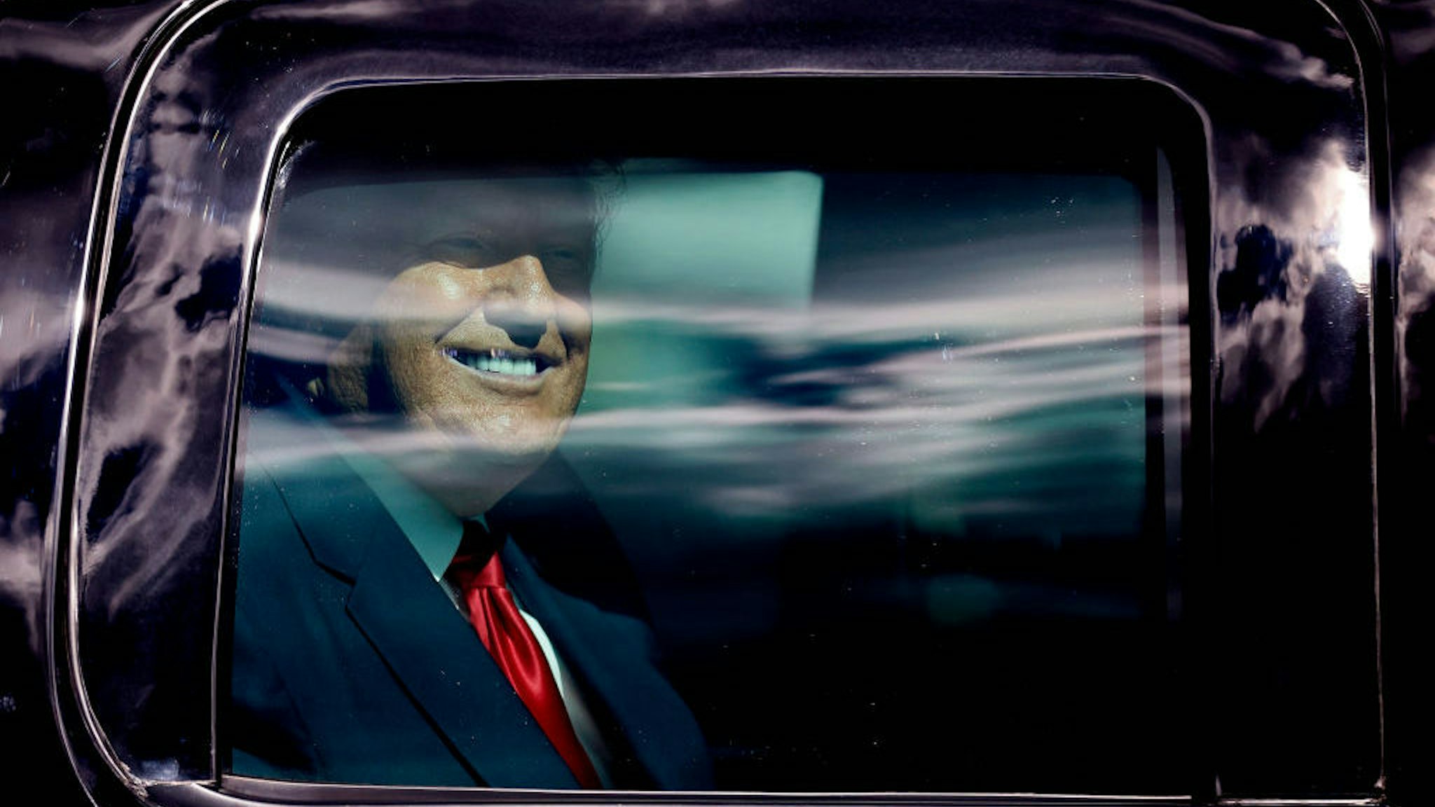 WEST PALM BEACH, FLORIDA - JANUARY 20: Outgoing US President Donald Trump waves to supporters lined along on the route to his Mar-a-Lago estate on January 20, 2021 in West Palm Beach, Florida. Trump, the first president in more than 150 years to refuse to attend his successor's inauguration, is expected to spend the final minutes of his presidency at his Mar-a-Lago estate in Florida. (Photo by Michael Reaves/Getty Images)