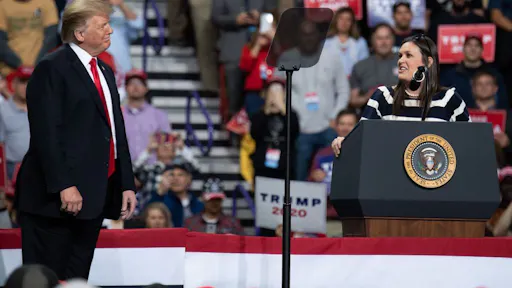 Donald Trump, Sarah Sanders White House Press Secretary Sarah Huckabee Sanders (R) speaks alongside US President Donald Trump during a Make America Great Again rally in Green Bay, Wisconsin, April 27, 2019. (Photo by SAUL LOEB / AFP) (Photo credit should read SAUL LOEB/AFP via Getty Images)