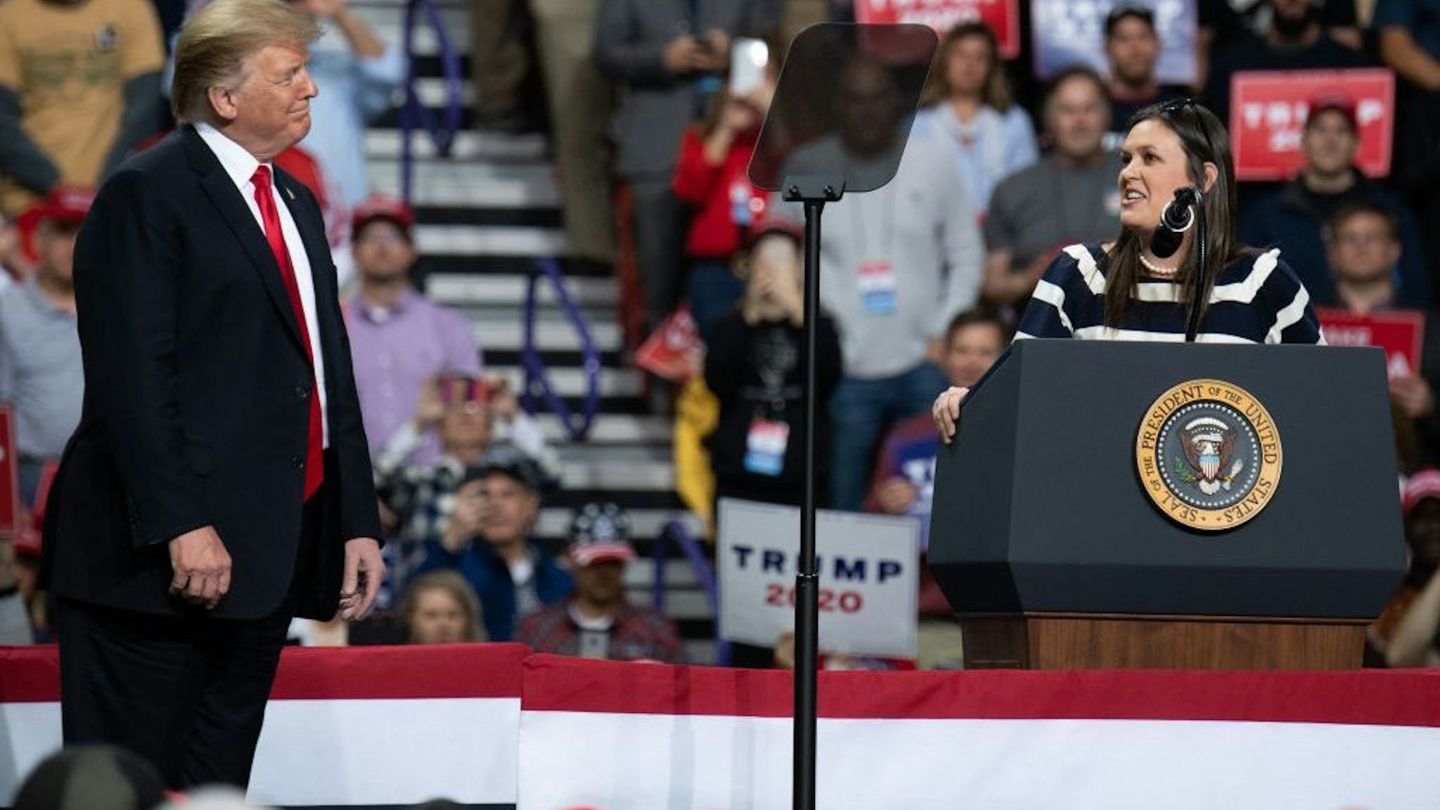 White House Press Secretary Sarah Huckabee Sanders (R) speaks alongside US President Donald Trump during a Make America Great Again rally in Green Bay, Wisconsin, April 27, 2019. (Photo by SAUL LOEB / AFP) (Photo credit should read SAUL LOEB/AFP via Getty Images)