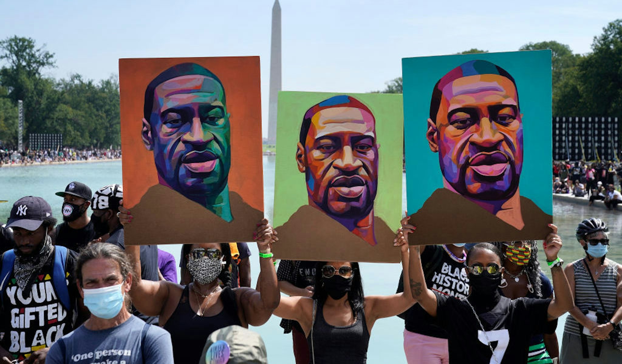 WASHINGTON, DC - AUGUST 28: Attendees hold images of George Floyd as they participate in the March on Washington at the Lincoln Memorial August 28, 2020 in Washington, DC. Today marks the 57th anniversary of Rev. Martin Luther King Jr.'s "I Have A Dream" speech at the same location. (Photo by Drew Angerer/Getty Images)