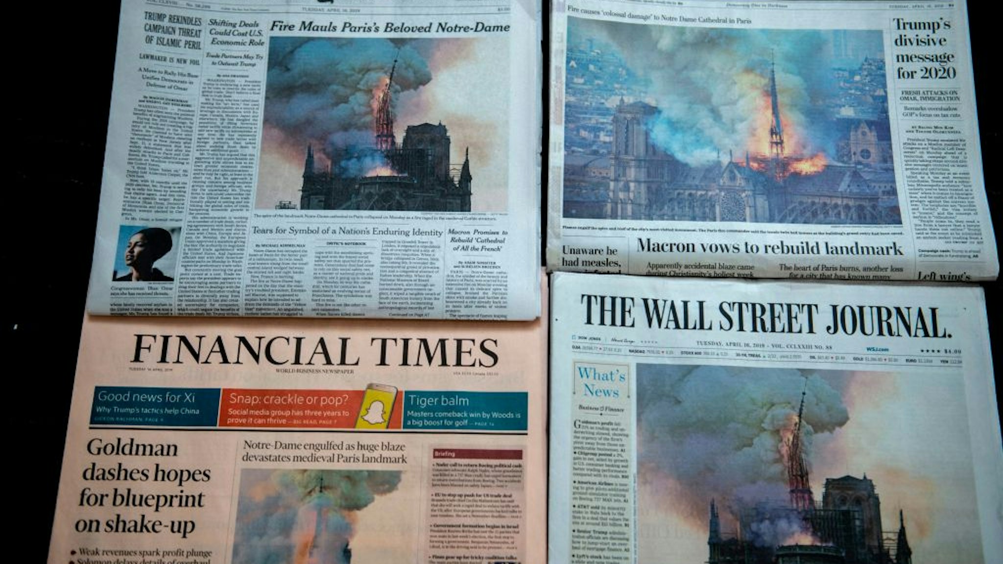 The US Newspapers editions of the New York Times, The Washington Post, The Wall Street Journal and the Financial Times display images of Notre-Dame Cathedral burning in Paris on their front page on April 16, 2019 in Washington DC.