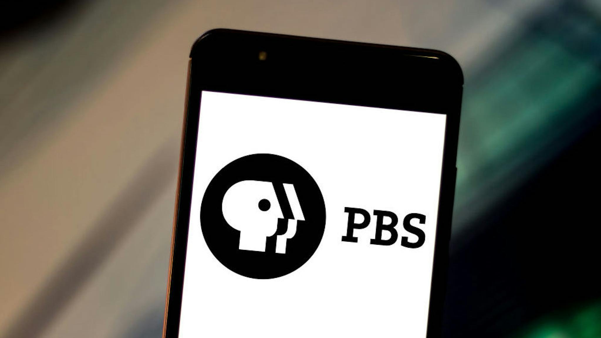 In this photo illustration the Public Broadcasting Service ( In this photo illustration the Public Broadcasting Service (PBS) logo is displayed on a smartphone.