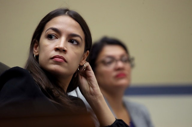 WASHINGTON, DC - JULY 18: Rep. Alexandria Ocasio-Cortez (L) (D-NY) and Rep. Rashida Tlaib (D-MI) listen to testimony from acting Homeland Security Secretary Kevin McAleenan while he testifies before the House Oversight and Reform Committee on July 18, 2019 in Washington, DC. The hearing is on "The Trump Administration's Child Separation Policy." (Photo by Win McNamee/Getty Images)