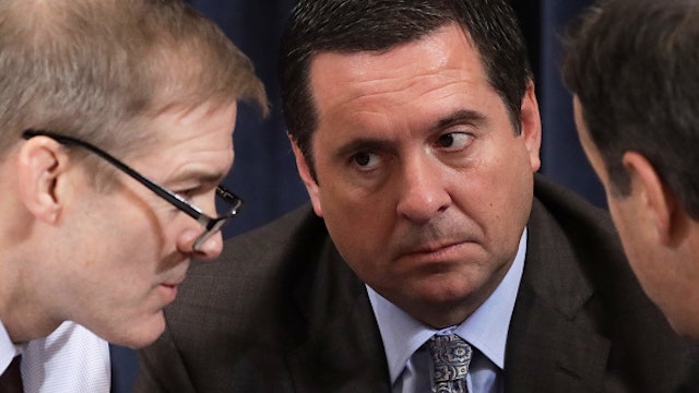 WASHINGTON, DC – DECEMBER 09: Ranking member of House Intelligence Committee Rep. Devin Nunes (R-CA) (C) listens to Rep. Jim Jordan (R-OH) during a break in an impeachment hearing before the House Judiciary Committee in the Longworth House Office Building on Capitol Hill December 9, 2019 in Washington, DC. The hearing is being held for the Judiciary Committee to formally receive evidence in the impeachment inquiry of President Donald Trump, whom Democrats say held back military aid for Ukraine while demanding they investigate his political rivals. The White House declared it would not participate in the hearing.