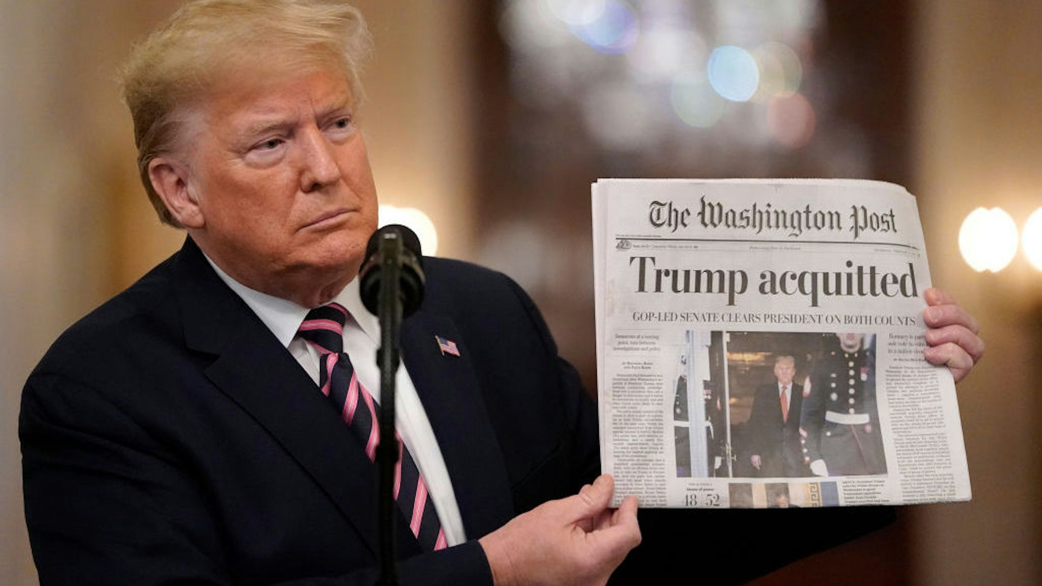 WASHINGTON, DC - FEBRUARY 06: U.S. President Donald Trump holds a copy of The Washington Post as he speaks in the East Room of the White House one day after the U.S. Senate acquitted on two articles of impeachment, ion February 6, 2020 in Washington, DC. After five months of congressional hearings and investigations about President Trump’s dealings with Ukraine, the U.S. Senate formally acquitted the president on Wednesday of charges that he abused his power and obstructed Congress. (Photo by Drew Angerer/Getty Images)