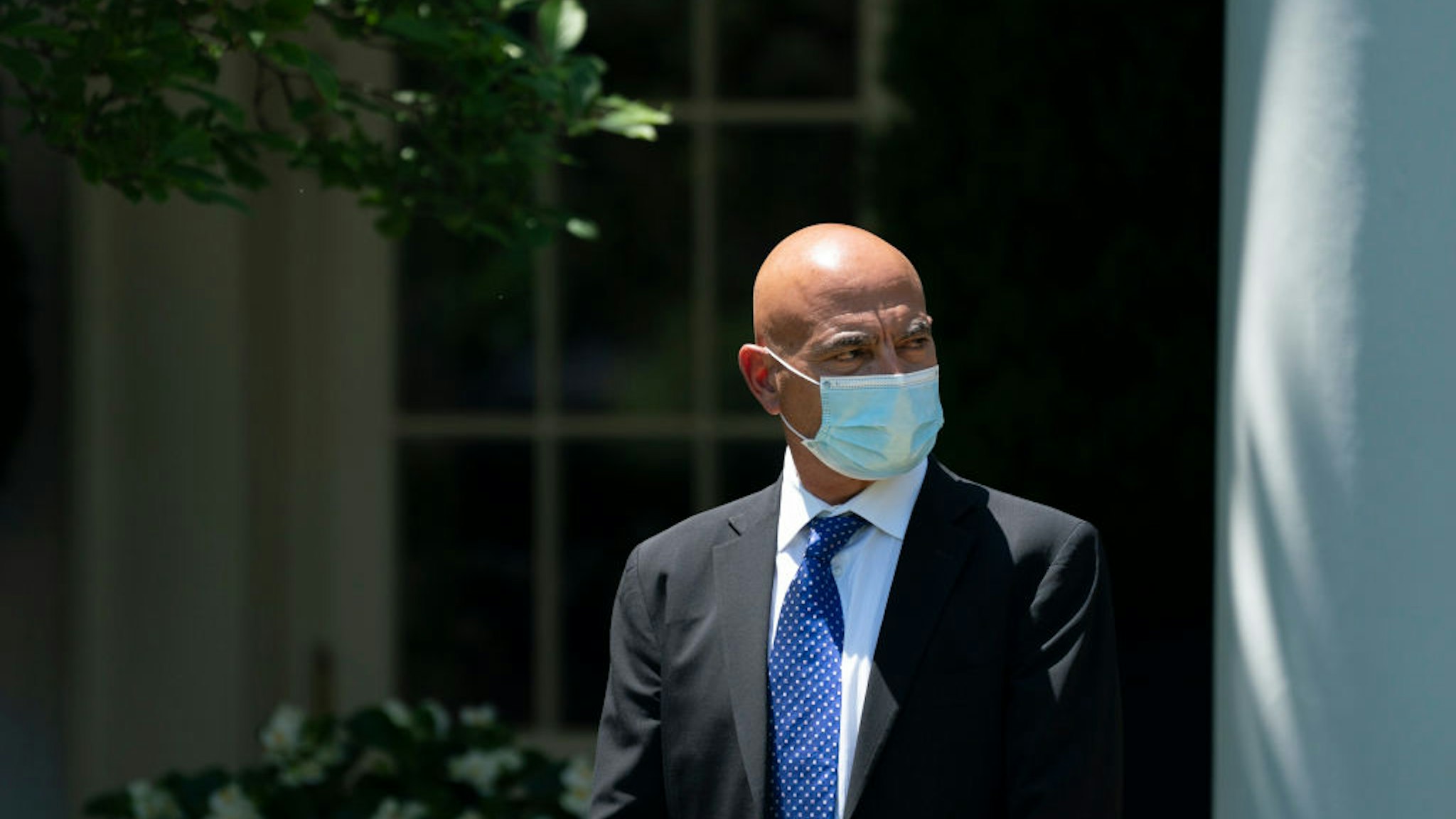 Moncef Slaoui, the former head of GlaxoSmithKlines vaccines division, listens as U.S. President Donald Trump delivers remarks about coronavirus vaccine development in the Rose Garden of the White House on May 15, 2020 in Washington, DC.