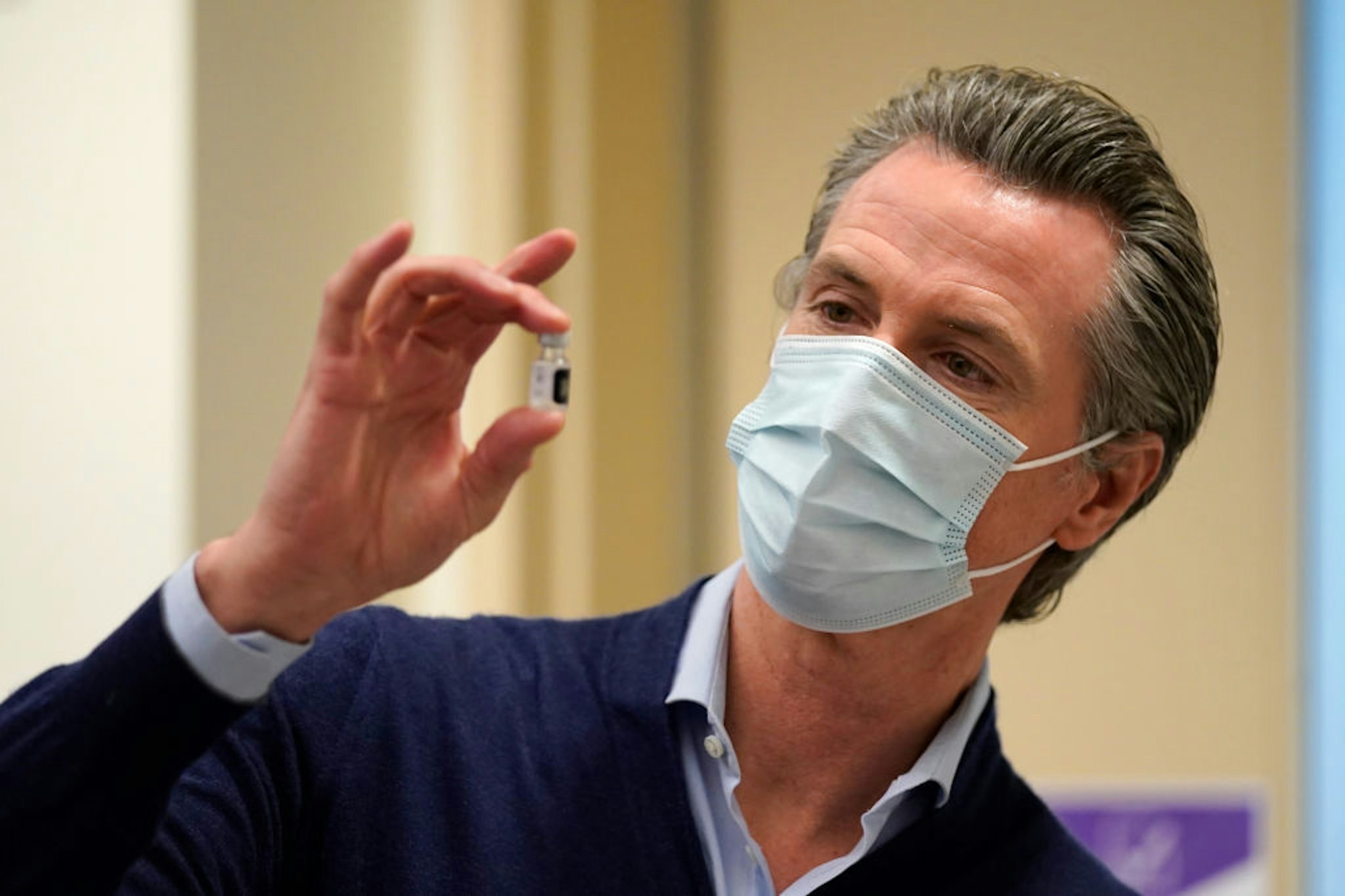 Gov. Gavin Newsom holds up a vial of the Pfizer-BioNTech COVID-19 vaccine at Kaiser Permanente Los Angeles Medical Center on December 14, 2020 in Los Angeles, California.