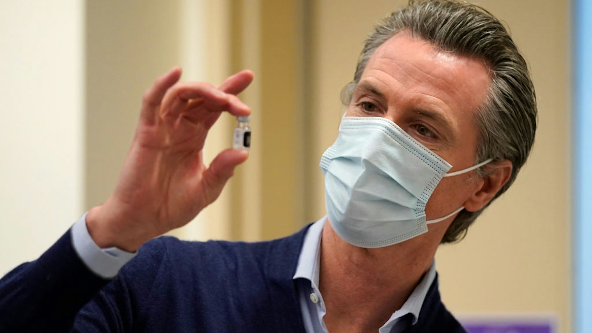 Gov. Gavin Newsom holds up a vial of the Pfizer-BioNTech COVID-19 vaccine at Kaiser Permanente Los Angeles Medical Center on December 14, 2020 in Los Angeles, California.