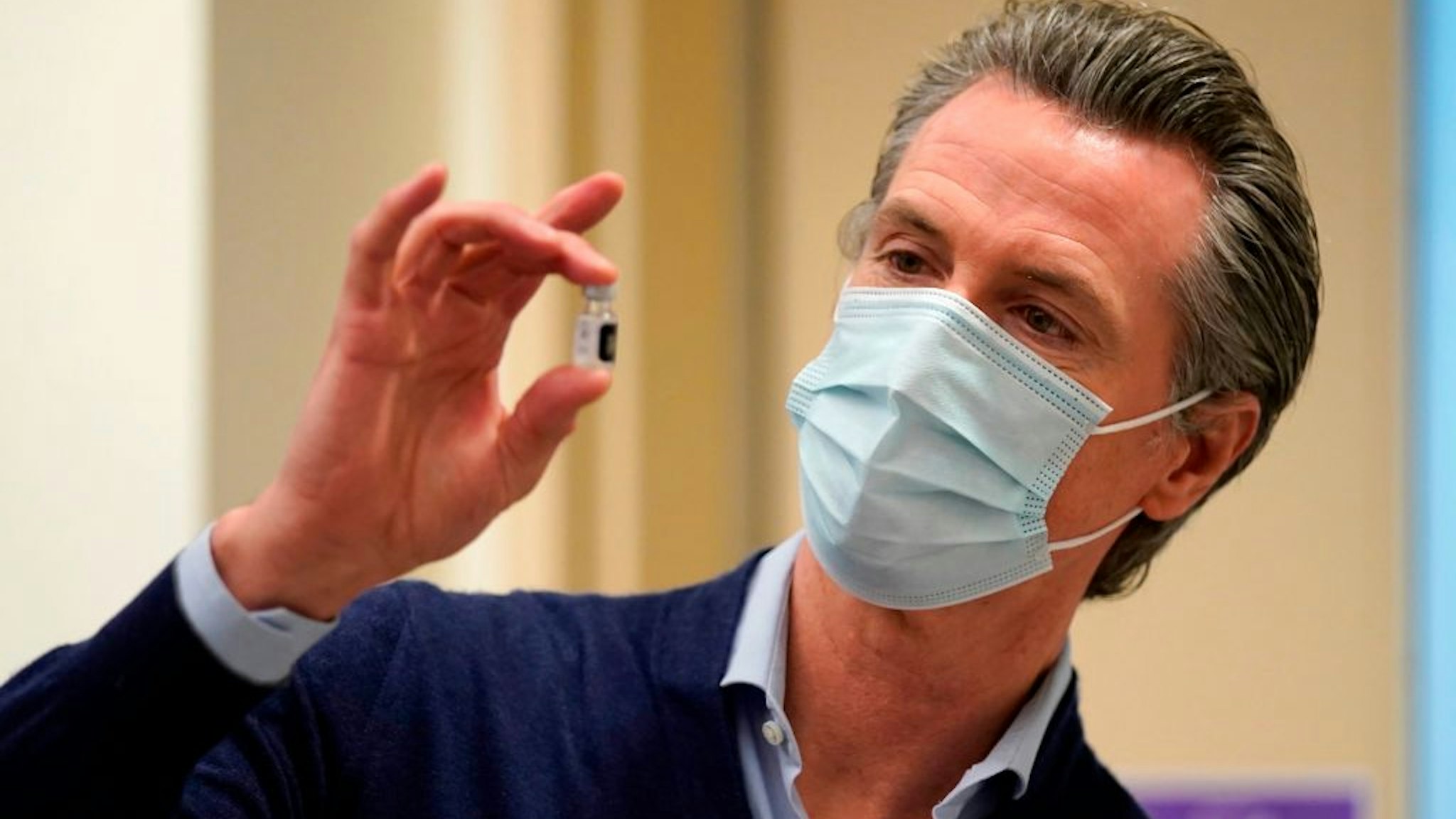 Governor Gavin Newsom holds up a vial of the Pfizer-BioNTech COVID-19 vaccine at Kaiser Permanente Los Angeles Medical Center in Los Angeles, California on December 14, 2020. - The United States kicked off a mass vaccination drive Monday hoping to turn the tide on the world's biggest coronavirus outbreak, as the country's death toll neared a staggering 300,000. (Photo by Jae Hong / POOL / AFP) (Photo by JAE HONG/POOL/AFP via Getty Images)