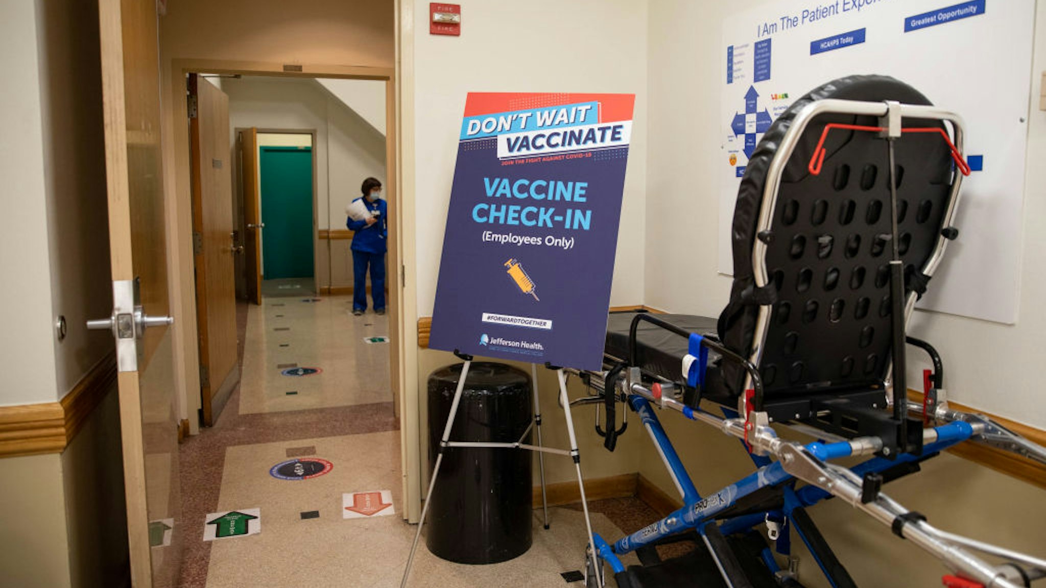 A sign signifies the check-in location for people waiting to be vaccinated for the Covid-19 vaccine at Thomas Jefferson University Hospital in Philadelphia, Pennsylvania on December 16, 2020.