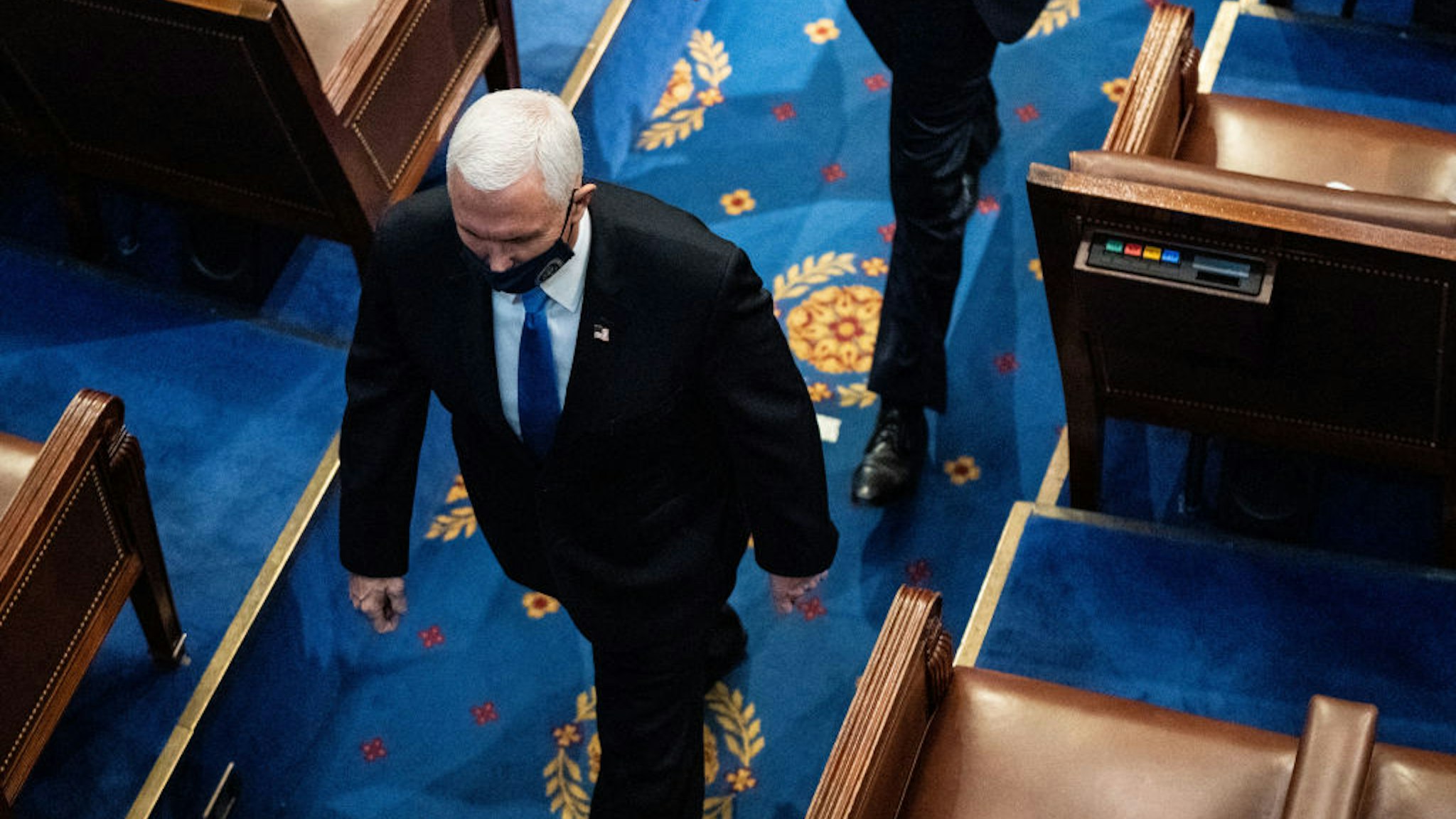 WASHINGTON, DC - JANUARY 06: U.S. Vice President Mike Pence walks off the House floor during a joint session of Congress to certify the 2020 Electoral College results on January 6, 2021 in Washington, DC. Congress held a joint session today to ratify President-elect Joe Biden's 306-232 Electoral College win over President Donald Trump. A group of Republican senators said they would reject the Electoral College votes of several states unless Congress appointed a commission to audit the election results. (Photo by Erin Schaff-Pool/Getty Images)