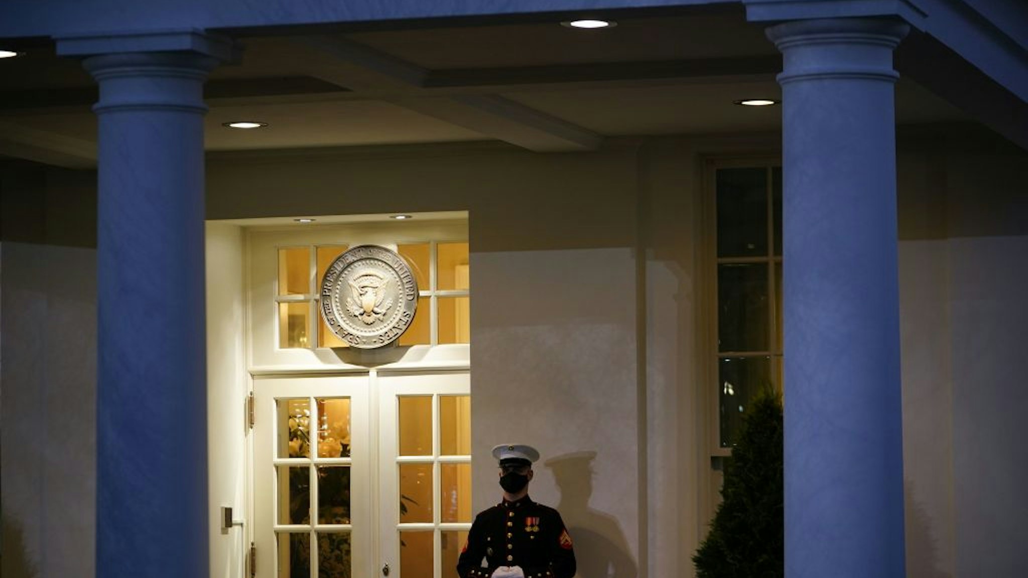 A US Marine stands guard outside of the West Wing at dusk on US President Donald Trump's final full day in office, in Washington, DC on January 19, 2021. - President Donald Trump began his final full day in the White House on January 19, 2021 with a long list of possible pardons to dish out before snubbing his successor Joe Biden's inauguration and leaving for Florida. On January 20, 2021 at noon, Biden will be sworn in and the Trump presidency will end, turning the page on some of the most disruptive, divisive years the United States has seen since the 1960s. (Photo by MANDEL NGAN / AFP) (Photo by MANDEL NGAN/AFP via Getty Images)