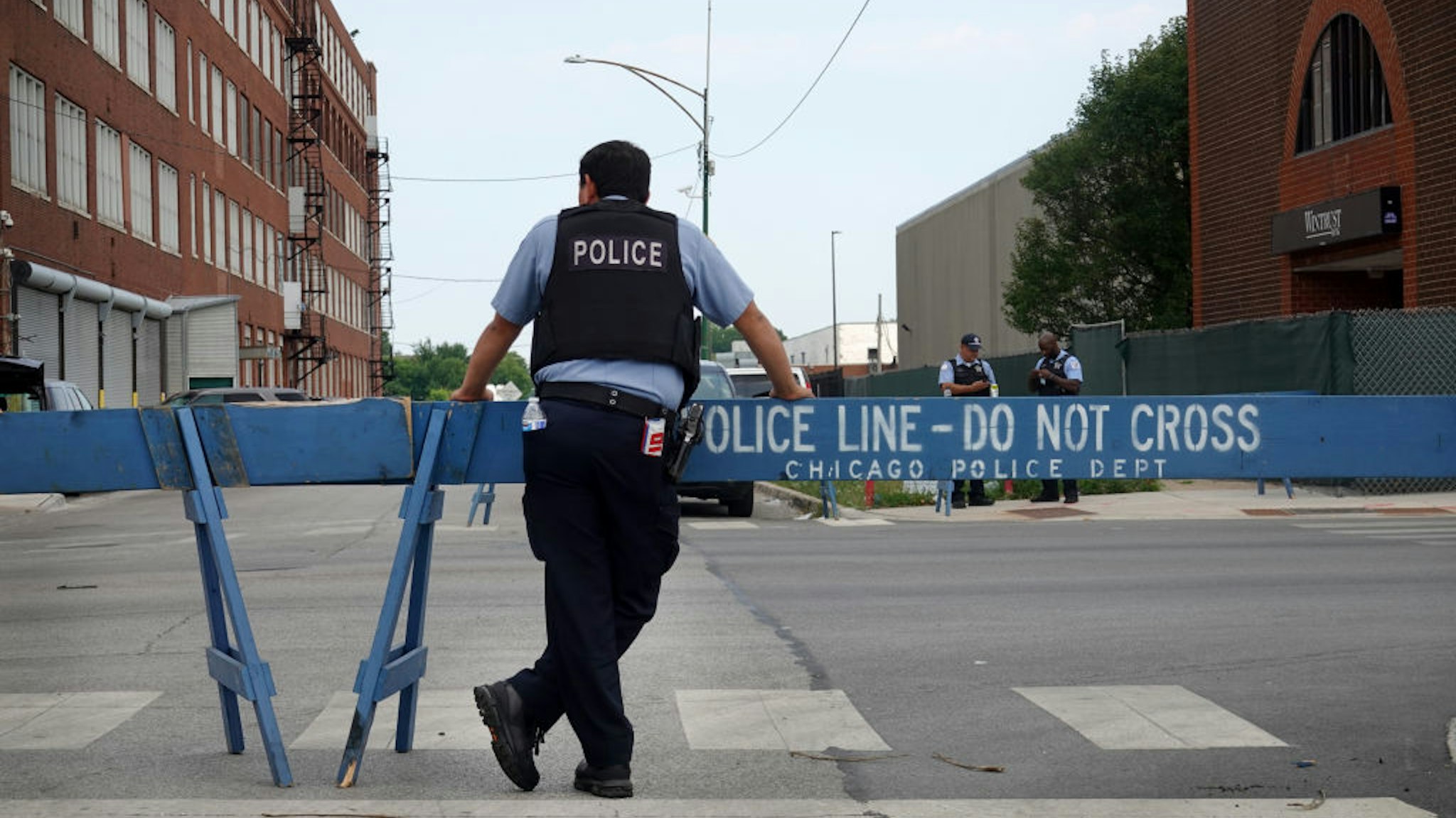 CHICAGO, ILLINOIS - AUGUST 15: Police stand guard as pro and anti-police demonstrators are expected to gather outside of the Homan Square police station on August 15, 2020 in Chicago, Illinois. The demonstration was one of several in the city today, either in support of or in opposition to police. (Photo by Scott Olson/Getty Images)