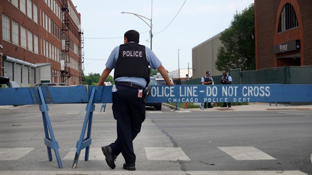 CHICAGO, ILLINOIS - AUGUST 15: Police stand guard as pro and anti-police demonstrators are expected to gather outside of the Homan Square police station on August 15, 2020 in Chicago, Illinois. The demonstration was one of several in the city today, either in support of or in opposition to police. (Photo by Scott Olson/Getty Images)