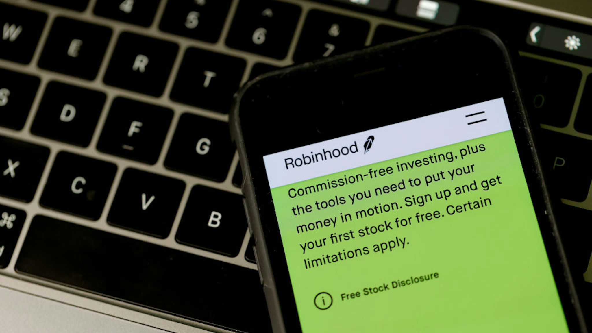 SAN ANSELMO, CALIFORNIA - DECEMBER 17: In this photo illustration, a notification about commission-free trading is displayed on the Robinhood application on December 17, 2020 in San Anselmo, California. The Securities and Exchange Commission has charged Silicon Valley start-up company Robinhood with deceiving customers about how the company makes money. The company has agreed to pay a $65 million civil penalty. (Photo Illustration by Justin Sullivan/Getty Images)