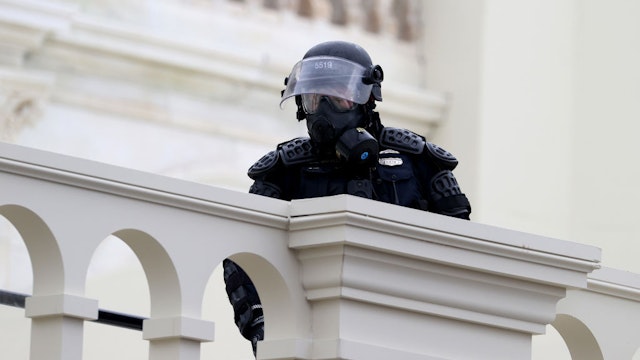 WASHINGTON, DC - JANUARY 06: A police officers in riot gear is seen on the U.S. Capitol as protesters enter the building on January 06, 2021 in Washington, DC. Trump supporters gathered in the nation's capital today to protest the ratification of President-elect Joe Biden's Electoral College victory over President Trump in the 2020 election. (Photo by Tasos Katopodis/Getty Images)