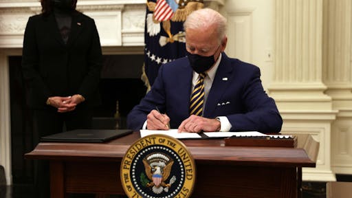 President Biden U.S. President Joe Biden signs an executive order as Vice President Kamala Harris looks on during an event on economic crisis in the State Dining Room of the White House January 22, 2021 in Washington, DC.