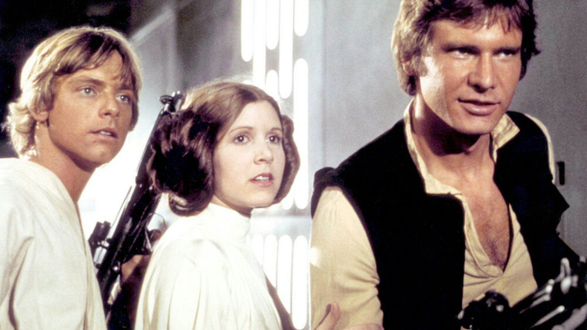 American actors Mark Hamill, Carrie Fisher and Harrison Ford on the set of Star Wars: Episode IV - A New Hope written, directed and produced by Georges Lucas.