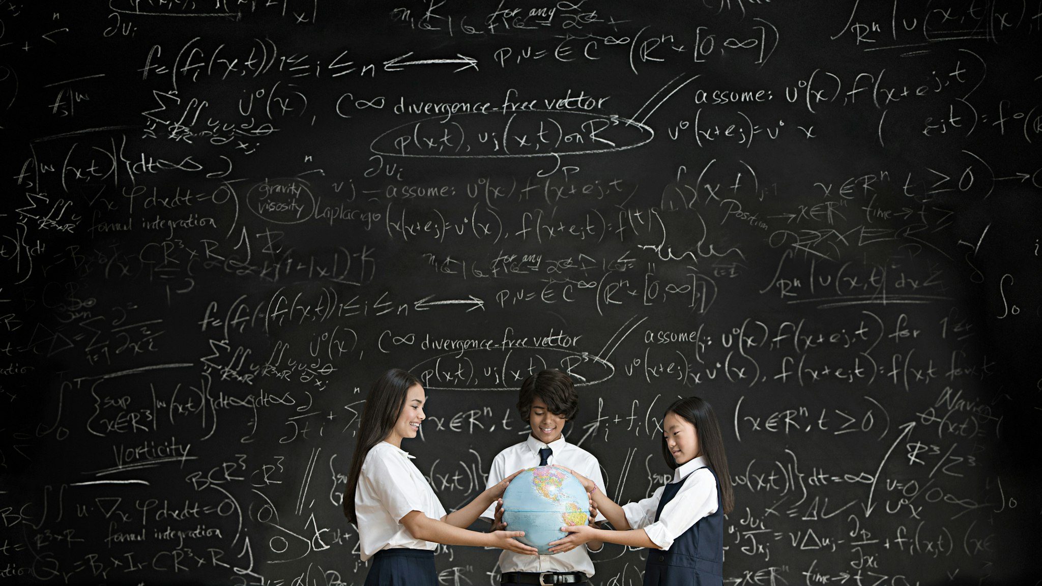 Students with globe in front of blackboard - stock photo