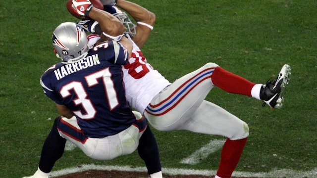 UNITED STATES - FEBRUARY 03: New York Giants' wide receiver David Tyree pins the ball to his helmet as he catches a 32-yard pass late in the fourth quarter of Super Bowl XLII against the New England Patriots at the University of Phoenix Stadium. The play continued a drive that led to the eventual game-winning touchdown as the Giants went on to pull off an upset victory beating the Patriots, 17-14. (Photo by Ron Antonelli/NY Daily News Archive via Getty Images)