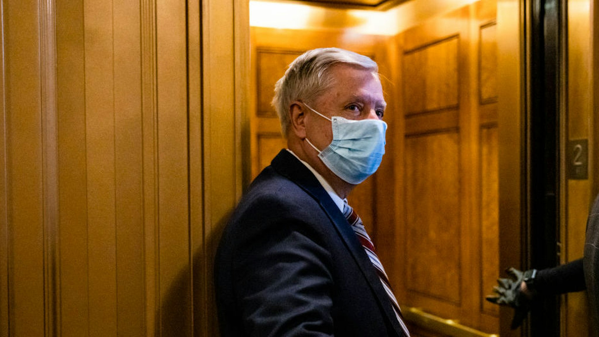WASHINGTON, DC - JANUARY 26: Senator Lindsey Graham (R-SC) leaves the floor of the Senate following a vote on January 26, 2021 in Washington, DC. Today senators will be sworn in as the jury for the second impeachment trial of former President Donald Trump. Senate President pro tempore Patrick Leahy (D-VT) will preside over the trial in place of Supreme Court Chief Justice John Roberts.