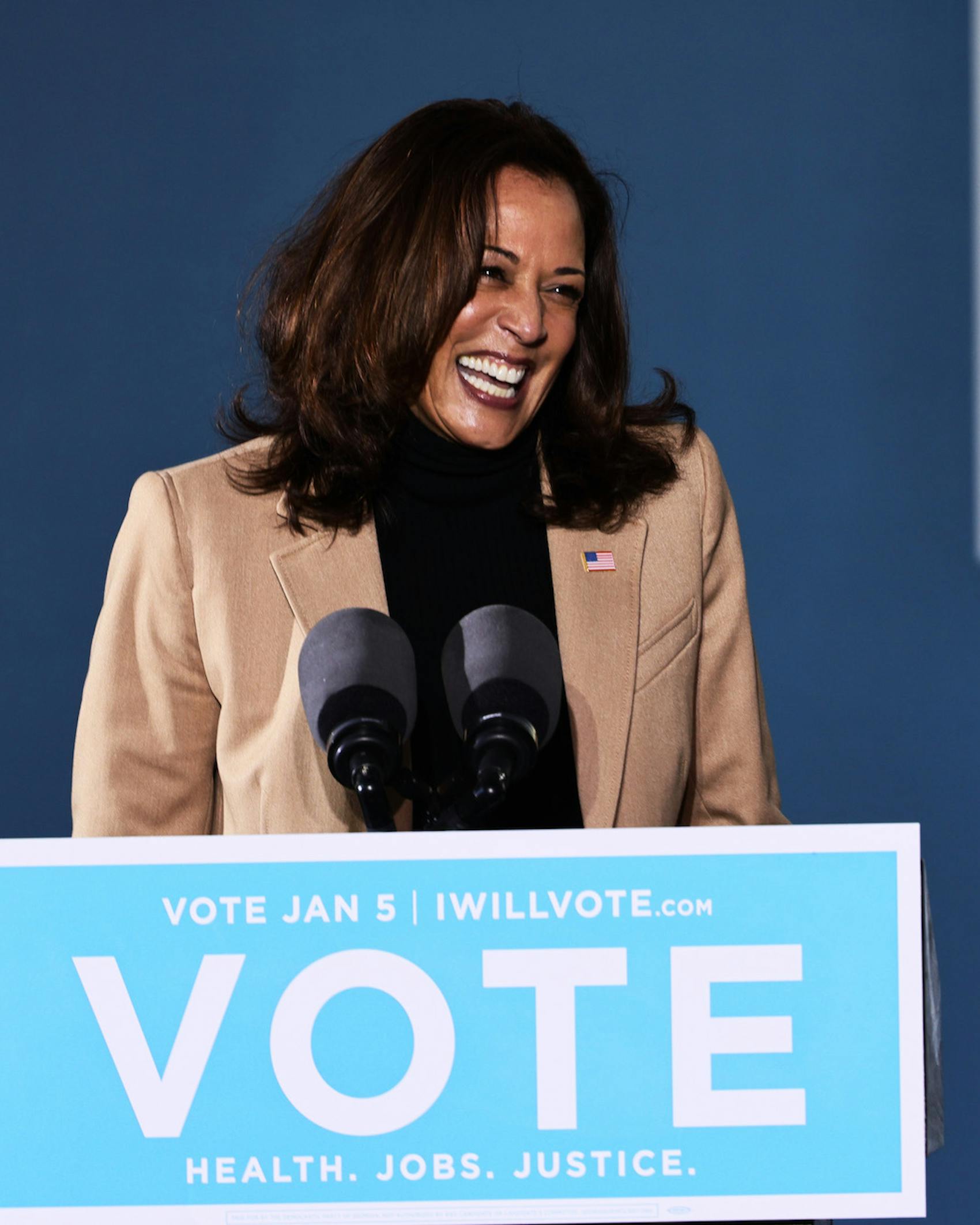 Kamala Harris Vice President-elect Kamala Harris speaks during a drive-in rally at Garden City Stadium on January 03, 2021 in Savannah, Georgia. Vice President-elect Kamala Harris joined Georgia Democratic Senate candidates Rev. Raphael Warnock and Jon Ossoff for a campaign event two days before the January 5th runoff election that has implications into which party controls the U.S. Senate. According to AJC, 3 million people have already casted their votes ahead of Tuesday's election. (Photo by Michael M. Santiago/Getty Images)