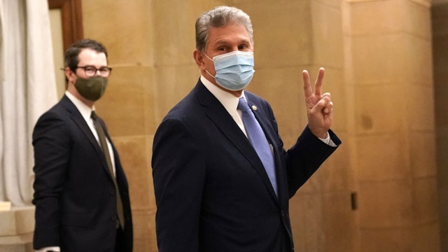 Senator Joe Manchin, a Democrat from West Virginia, wears a protective mask at the U.S. Capitol in Washington, D.C., U.S., on Wednesday, Jan. 6, 2021. Congress is meeting today to certify Joe Biden as the winner of the 2020 presidential election, with scores of Republican lawmakers preparing to challenge the tally in a number of states during what is normally a largely ceremonial event.