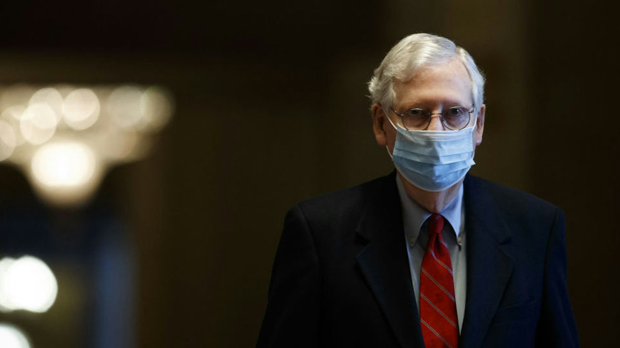 Senate Majority Leader Mitch McConnell, a Republican from Kentucky, wears a protective mask while walking through the U.S. Capitol Building in Washington, D.C., U.S., on Sunday, Dec. 20, 2020. Congressional negotiators cleared the last significant obstacle for pandemic relief legislation with a compromise in a dispute over the future of Federal Reserve emergency lending programs, setting up a possible vote on Sunday.