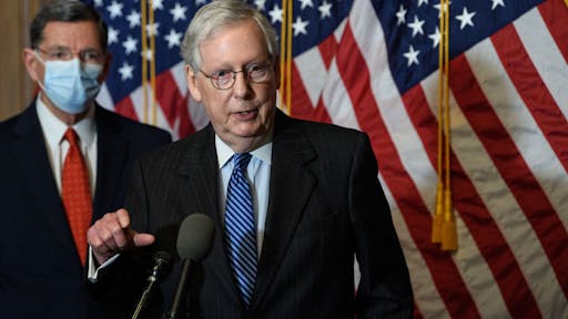 Mitch McConnell WASHINGTON, DC - DECEMBER 15: U.S. Senate Majority Leader Mitch McConnell (R-KY) arrives with Sen. John Thune (R-SD) at a news conference with other Senate Republicans at the U.S. Capitol on December 15, 2020 in Washington, DC. (Photo by Nicholas Kamm-Pool/Getty Images)