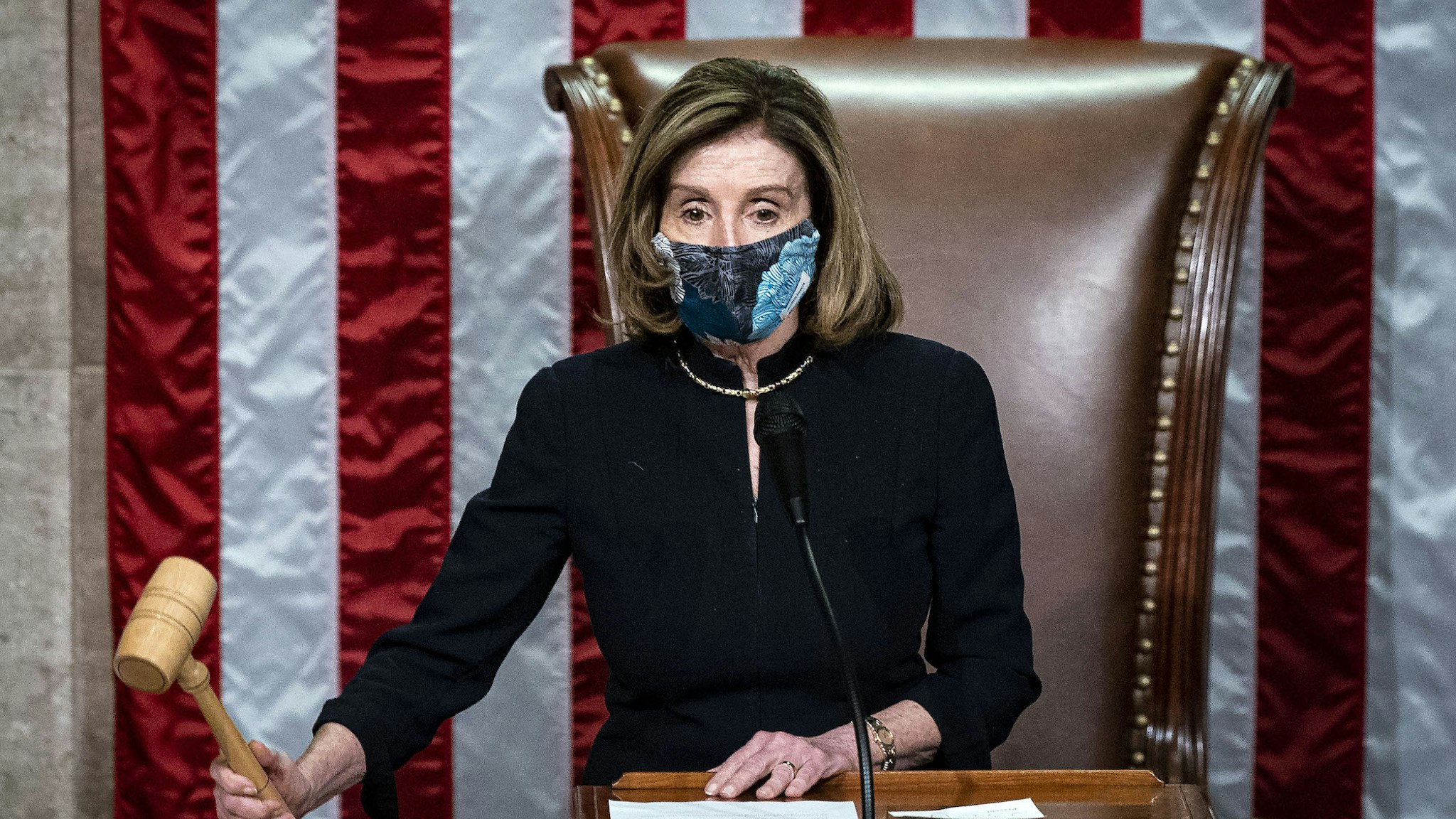 U.S. House Speaker Nancy Pelosi, a Democrat from California, wears a protective mask while banging the Speaker's gavel on the floor of the House at the U.S. Capitol in Washington, D.C., U.S., on Wednesday, Jan. 13, 2021. President Donald Trump was impeached by the U.S. House on a single charge of incitement of insurrection for his role in a deadly riot by his supporters that left five dead and the Capitol ransacked, putting an indelible stain on his legacy with only a week left in his term. Photographer: Al Drago/Bloomberg