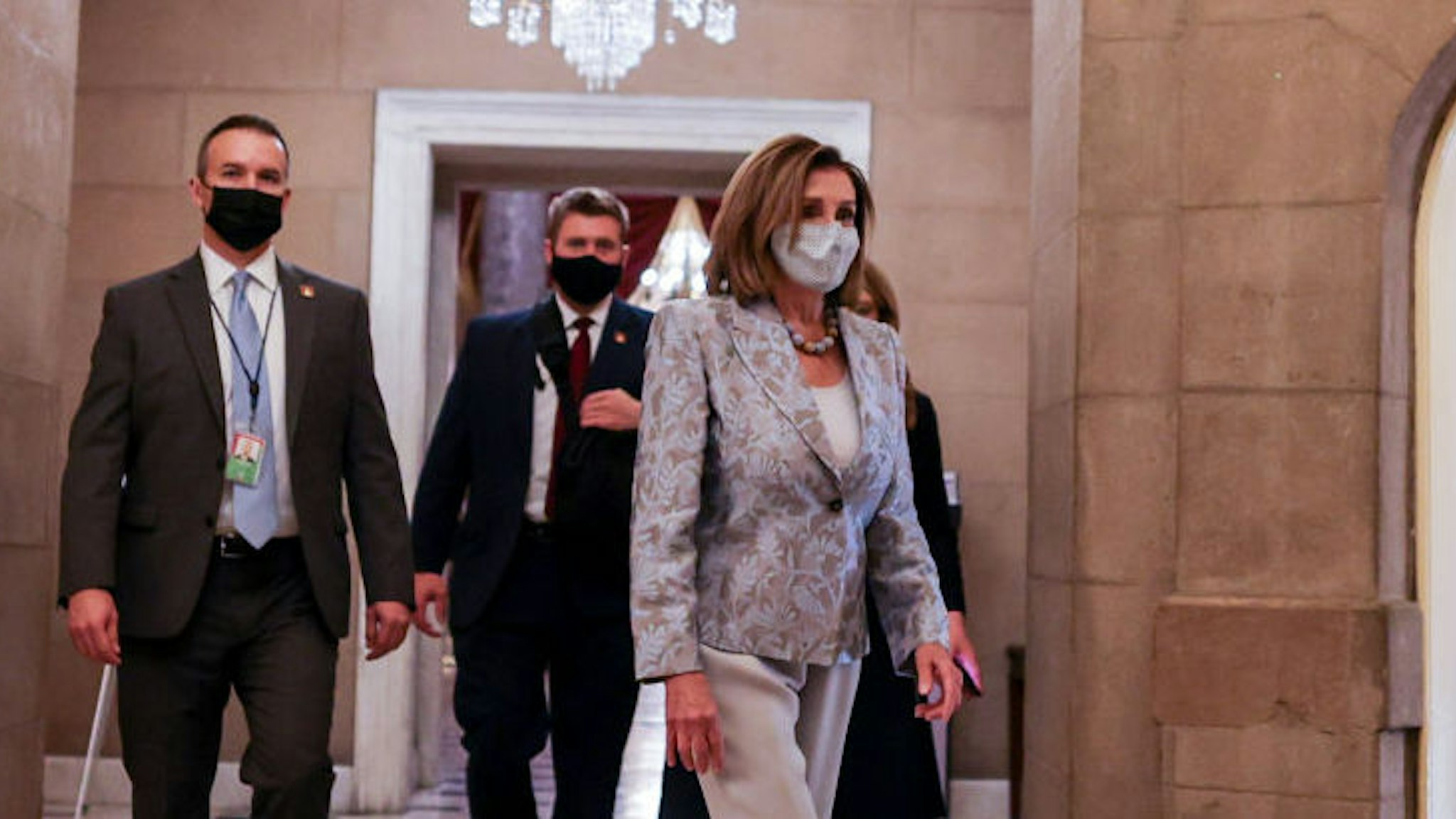 WASHINGTON, DC - JANUARY 03: Speaker of the House Nancy Pelosi (D-CA) walks back to her office after being in the house chamber in the US Capitol on January 03, 2021 in Washington, DC. Both chambers are holding rare Sunday sessions to open the new Congress on January 3 as the Constitution requires.