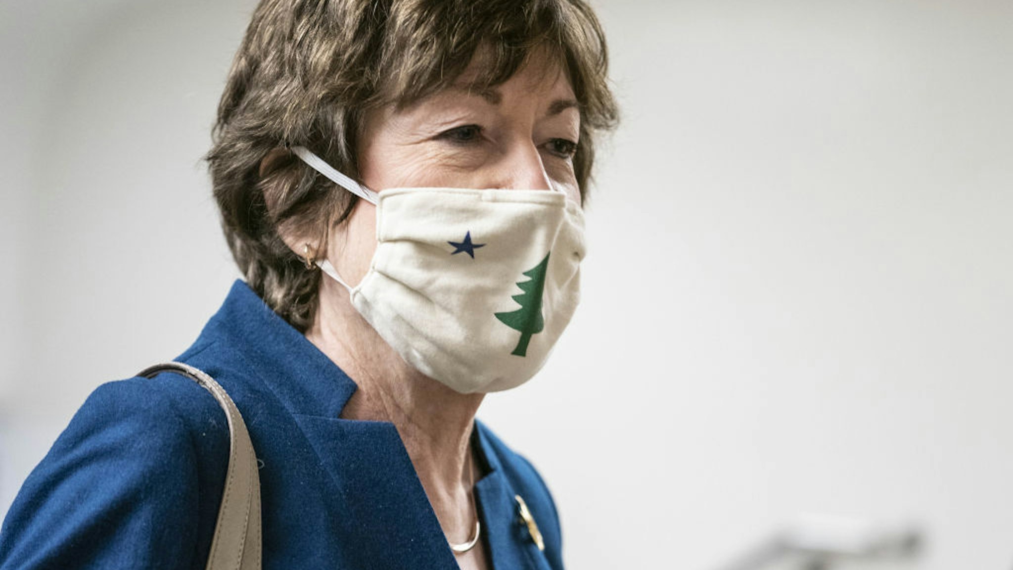Senator Susan Collins, a Republican from Maine, wears a protective mask while walking through the Senate Subway at the U.S. Capitol in Washington, D.C., U.S., on Thursday, Jan. 28, 2021. Democrats are preparing to move forward quickly on coronavirus relief measures with or without Republican help after early resistance from moderates to President Biden's $1.9 trillion proposal.