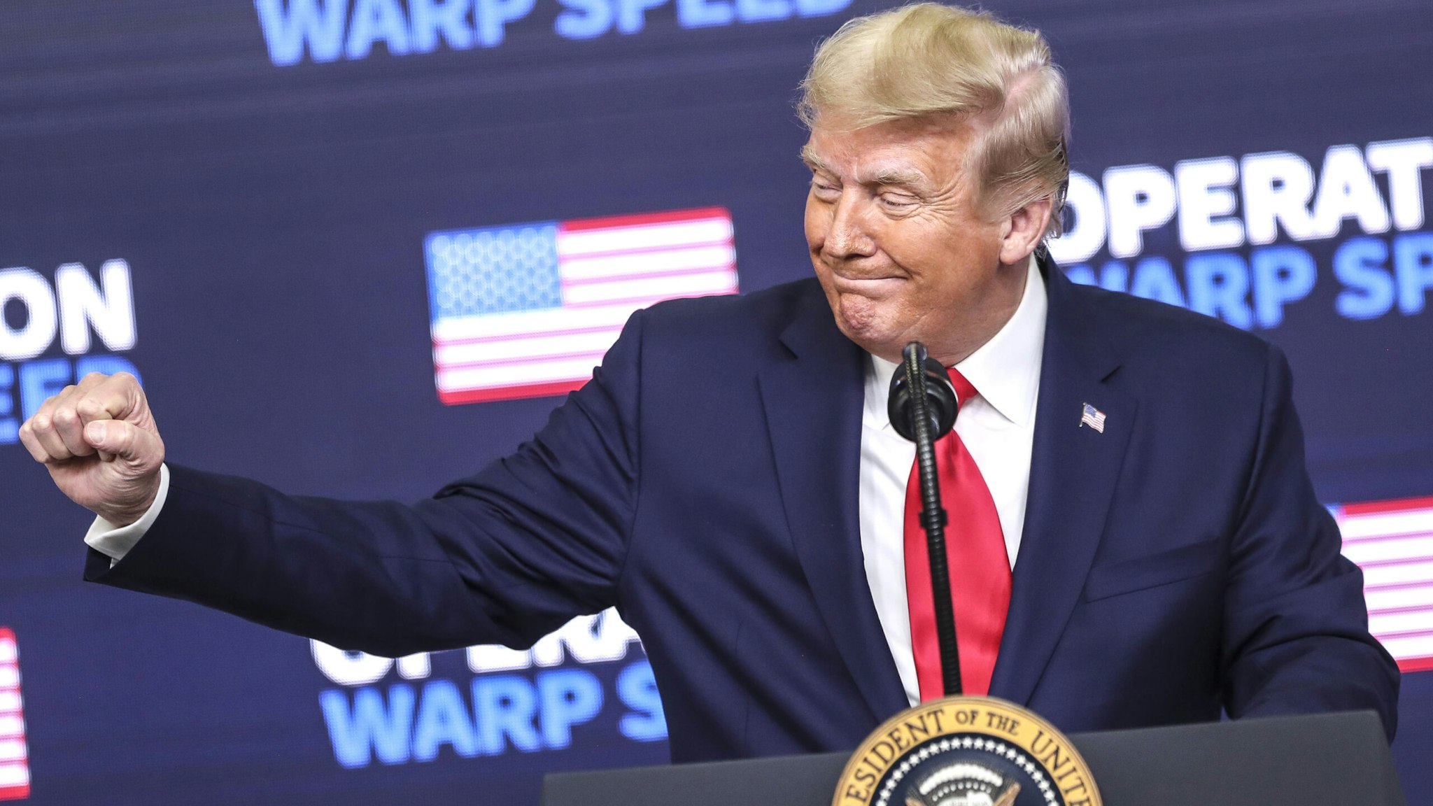 U.S. President Donald Trump gestures during an Operation Warp Speed vaccine summit at the White House in Washington, D.C., U.S., on Tuesday, Dec. 8, 2020. Trump celebrated the development of coronavirus vaccines at a White House summit on Tuesday and vowed to use executive powers if necessary to acquire sufficient doses, as the number of U.S. cases surpassed 15 million.