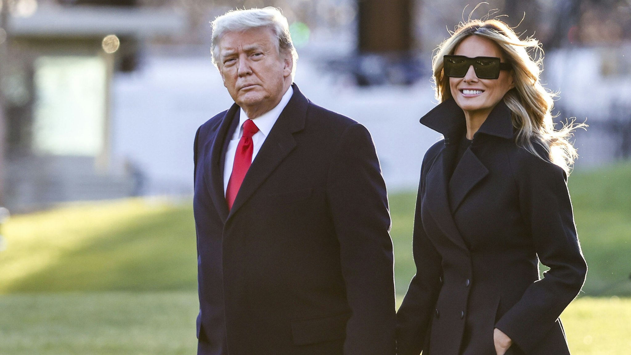 WASHINGTON, DC - DECEMBER 23: President Donald Trump and first lady Melania Trump walk on the south lawn of the White House on December 23, 2020 in Washington, DC. The Trumps are headed to Mar-a-Lago for the holidays with a government shutdown possible on Monday December 28.
