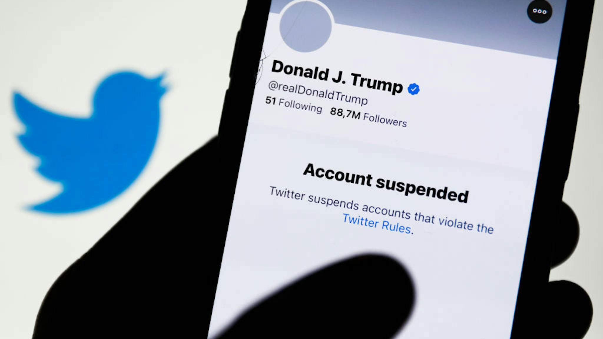 Trump suspended Donald Trump's Twitter account displayed on a phone screen and Twitter logo in the background are seen in this illustration photo taken in Poland on January 9, 2021. Twitter suspended Donald Trump's account because of violating the app rules. (Photo by Jakub Porzycki/NurPhoto via Getty Images)