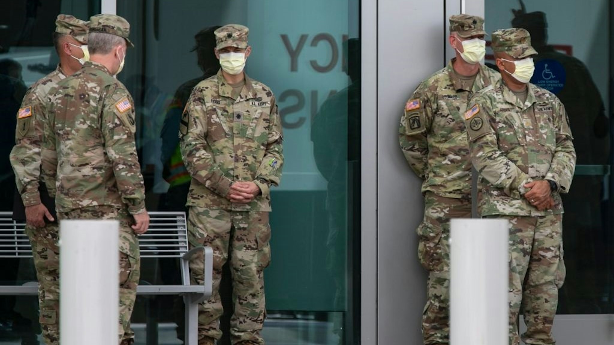 MIAMI BEACH, FL - APRIL 8: Members of the U.S. Army Corps of Engineers stand outside the Miami Beach Convention Center as they build a coronavirus field hospital inside the facility on April 8, 2020 in Miami Beach, Florida.