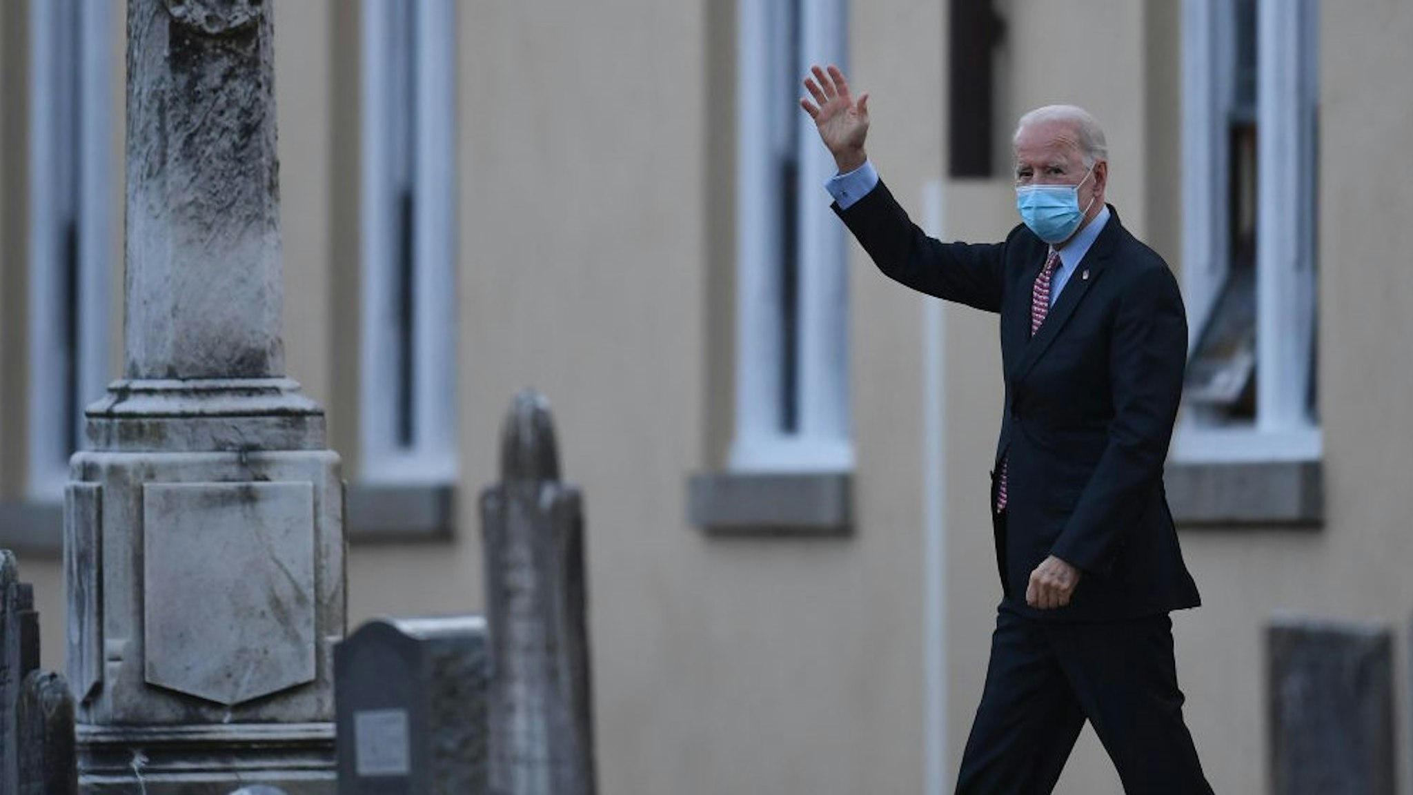 TOPSHOT - US President-elect Joe Biden waves as he leaves St. Joseph on the Brandywine Roman Catholic Church on January 16, 2021 in Wilmington, Delaware. - President-elect Joe Biden will sign executive orders on Inauguration Day next week to address the pandemic, the ailing US economy, climate change and racial injustice in America, a senior aide said Saturday. (Photo by Angela Weiss / AFP) (Photo by
