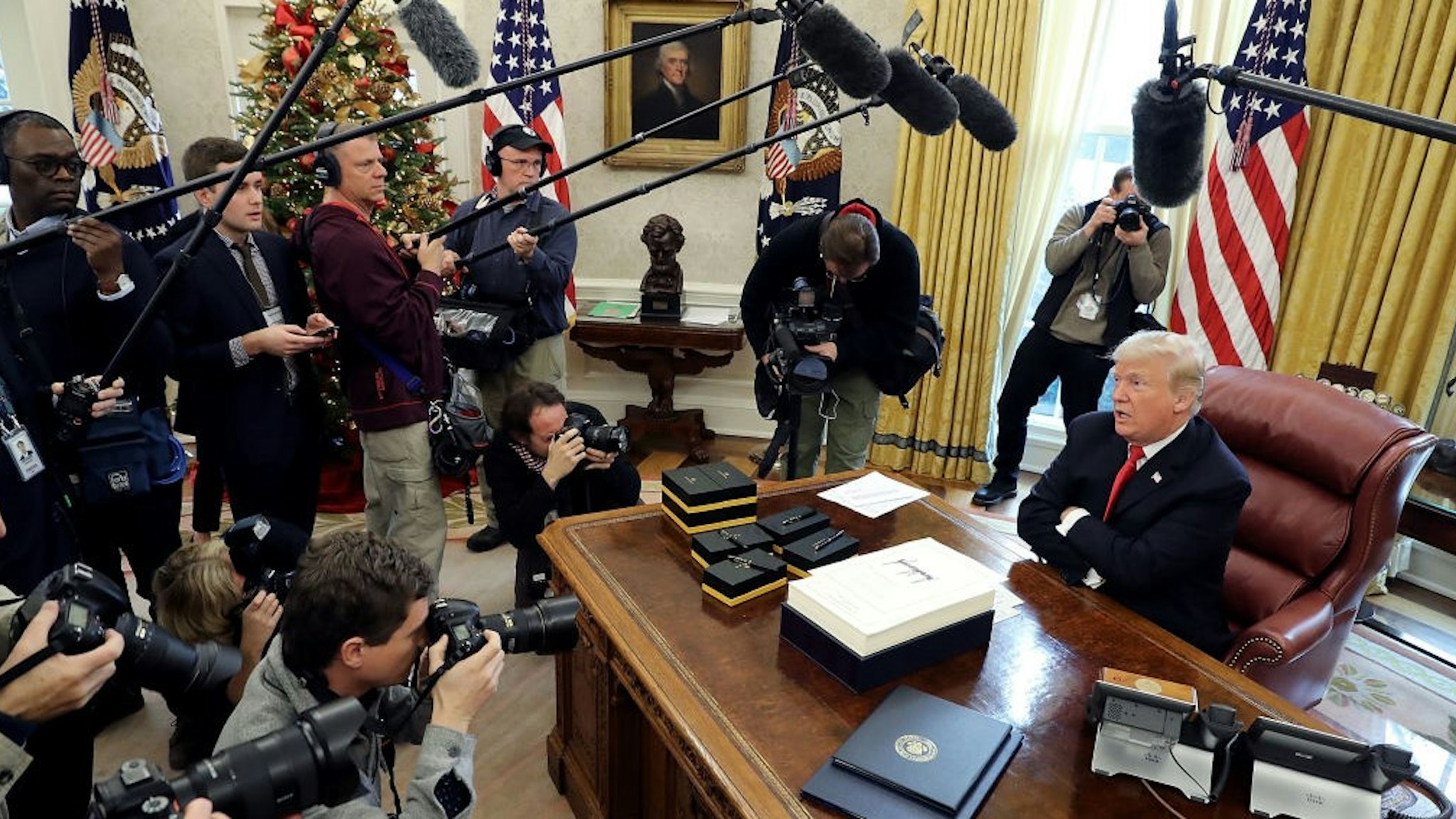 WASHINGTON, DC - DECEMBER 22: U.S. President Donald Trump talks with journalists after signing tax reform legislation in the Oval Office December 22, 2017 in Washington, DC. Trump praised Republican leaders in Congress for all their work on the biggest tax overhaul in decades. (Photo by