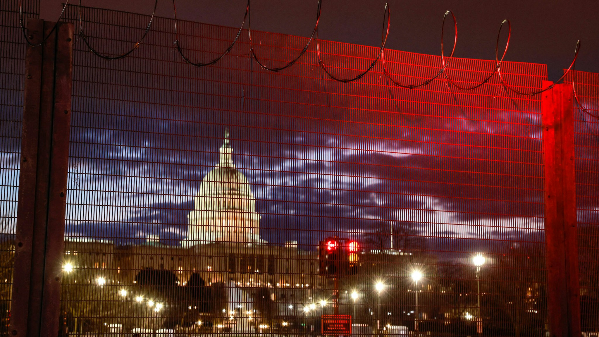 WASHINGTON, DISTRICT OF COLUMBIA, UNITED STATES - 2021/01/23: Razor wire and fences still surround the United States Capitol building at sunrise a few days after the inauguration of President Joe Biden and Vice President Kamala Harris. The Capitol was breached during an insurrection January 6 just days before the inauguration.