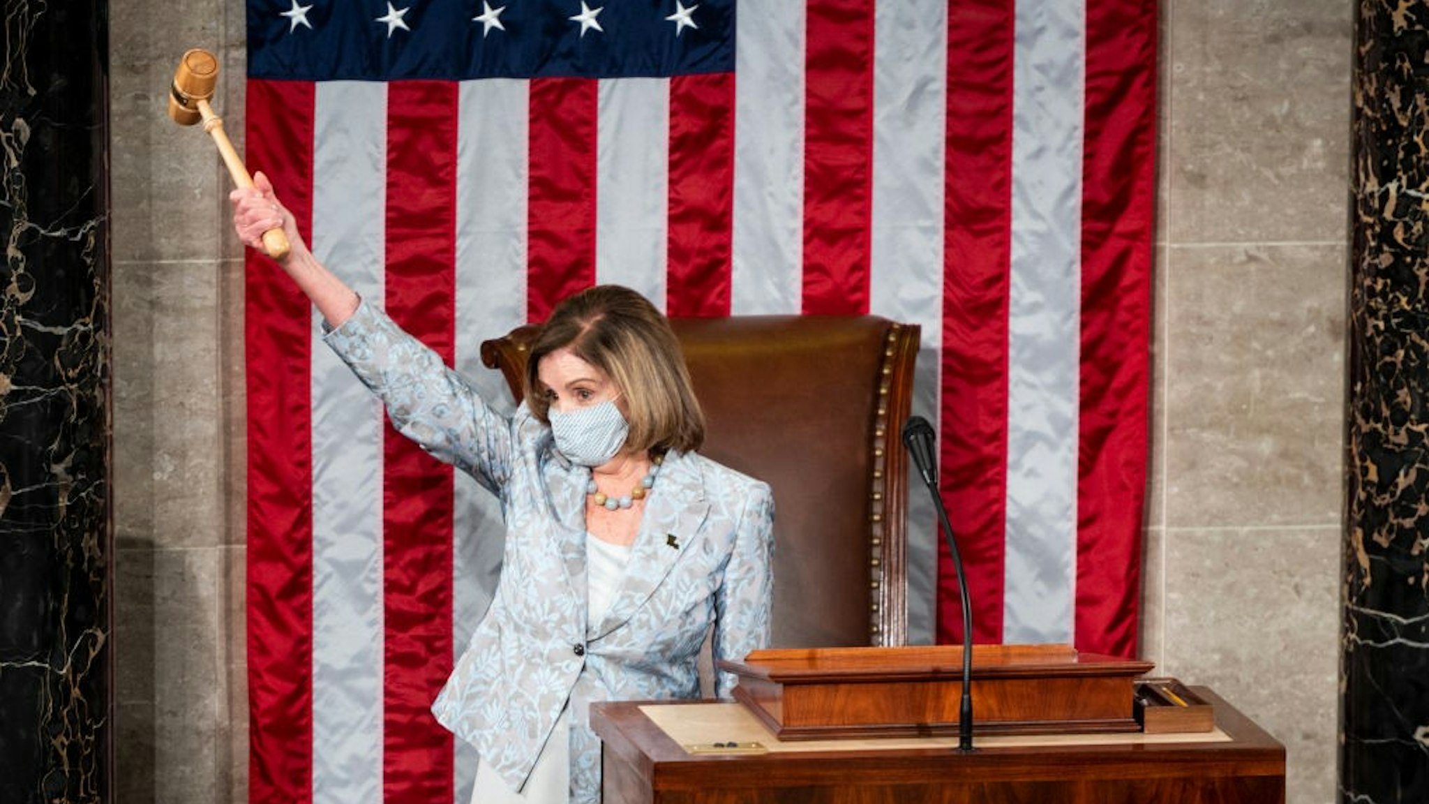WASHINGTON, DC - JANUARY 3: Speaker of the House Nancy Pelosi (D-CA) holds the Speakers gavel in the air on the House floor in the Capitol after becoming Speaker of the 117th Congress on January 3, 2021 in Washington, DC. Both chambers are holding rare Sunday sessions to open the new Congress on January 3 as the Constitution requires. (Photo By