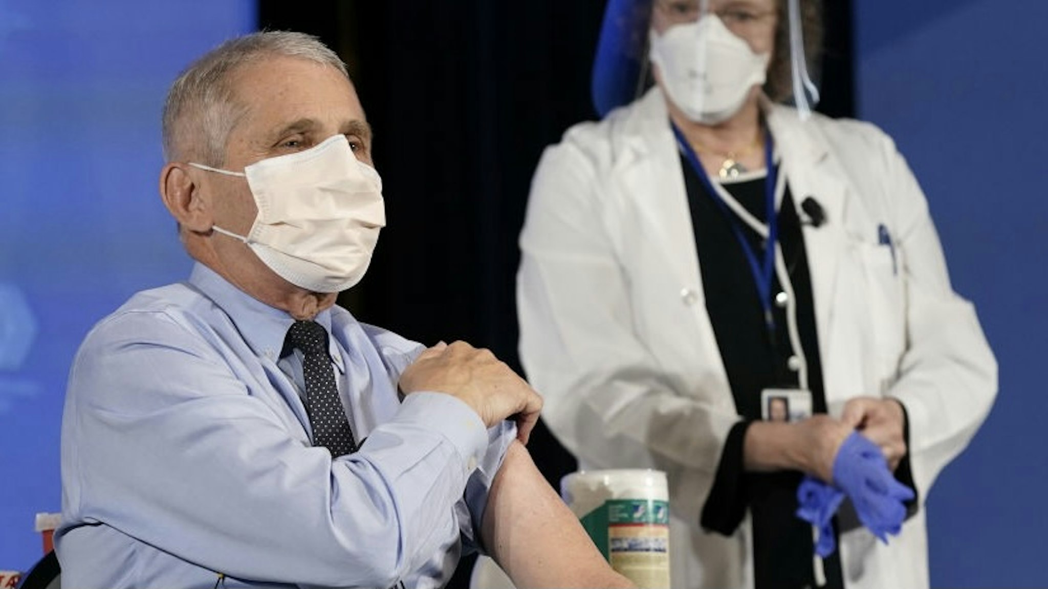 Anthony Fauci, director of the National Institute of Allergy and Infectious Diseases, left, speaks before receiving the Moderna Inc. Covid-19 vaccine during an event at the NIH Clinical Center Masur Auditorium in Bethesda, Maryland, U.S., on Tuesday, Dec, 22, 2020. The National Institutes of Health is holding a livestreamed vaccination event to kick-off the organization's efforts for its employees on the front line of the pandemic. Photographer: Patrick Semansky/Associated Press/Bloomberg