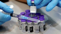 39CAB316-4BBF-490B-A051-940C445144C9_1_201_a A syringe and vials of the Pfizer-BioNTech COVID-19 vaccine are pictured at the Sheba Medical Center, Israel's largest hospital, in Ramat Gan near the coastal city of Tel Aviv, on January 14, 2021. - Israel's initial vaccination rollout appears to be unfolding successfully, with some two million citizens having received the first of two required injections of the Pfizer-BioNTech jab, a pace widely described as the world's fastest per capita. (Photo by JACK GUEZ / AFP) (Photo by JACK GUEZ/AFP via Getty Images)