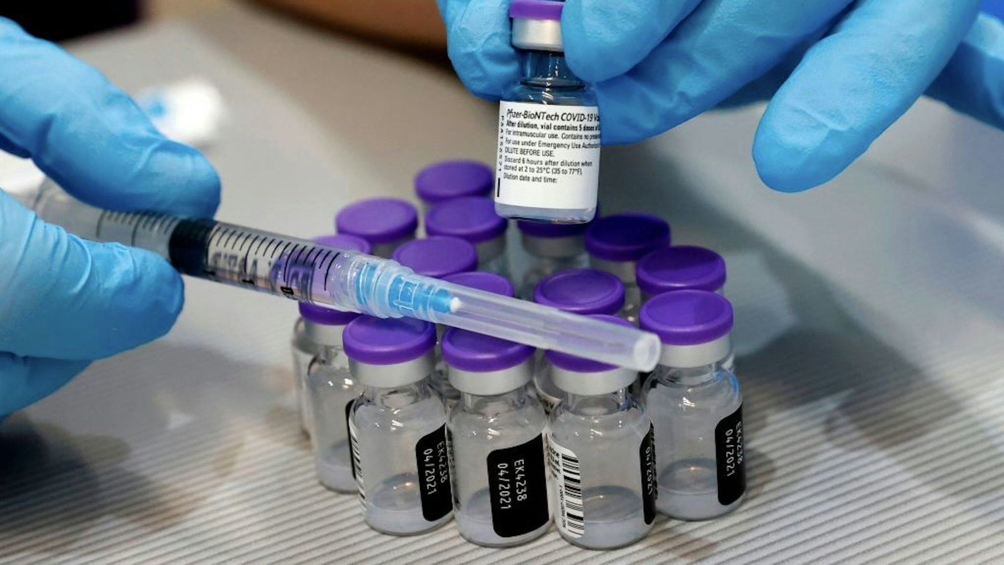 A syringe and vials of the Pfizer-BioNTech COVID-19 vaccine are pictured at the Sheba Medical Center, Israel's largest hospital, in Ramat Gan near the coastal city of Tel Aviv, on January 14, 2021. - Israel's initial vaccination rollout appears to be unfolding successfully, with some two million citizens having received the first of two required injections of the Pfizer-BioNTech jab, a pace widely described as the world's fastest per capita. (Photo by JACK GUEZ / AFP) (Photo by JACK GUEZ/AFP via Getty Images)