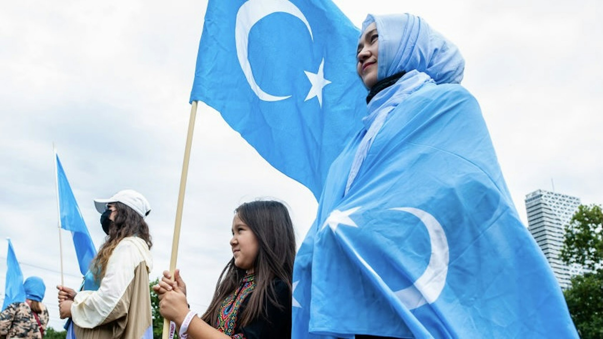 A woman and her daughter are holding Uyghur flags, during the demonstration 'Freedom for Uyghurs' in The Hague, Netherlands on August 20th, 2020. (Photo by Romy Arroyo Fernandez/NurPhoto)