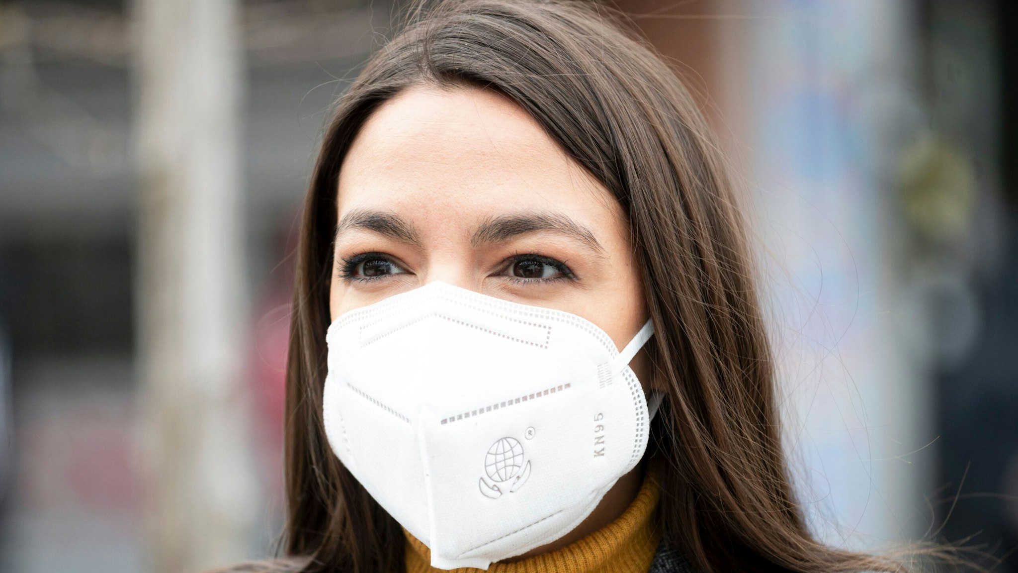 Democratic Congresswoman from New York Alexandria Ocasio-Cortez wears a face mask to protect herself from the coronavirus, during a press conference in the Corona neighbourhood of Queens on April 14, 2020 in New York City. - Senate Minority Leader Chuck Schumer and Democratic Rep. Alexandria Ocasio-Cortez hold a press conference amid the coronavirus pandemic to call on the Federal Emergency Management Administration (FEMA) to begin approving disaster funds to help families in lower-income communities and communities of color pay for funeral costs.