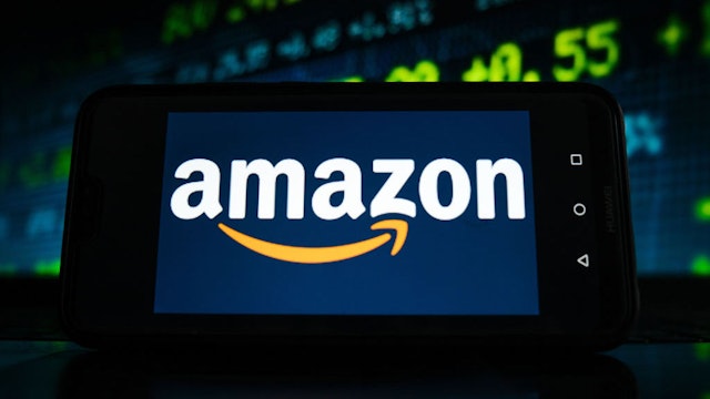 POLAND - 2021/02/05: In this photo illustration an Amazon logo seen displayed on a smartphone screen with stock market graphic on the background. (Photo Illustration by Omar Marques/SOPA Images/LightRocket via Getty Images)